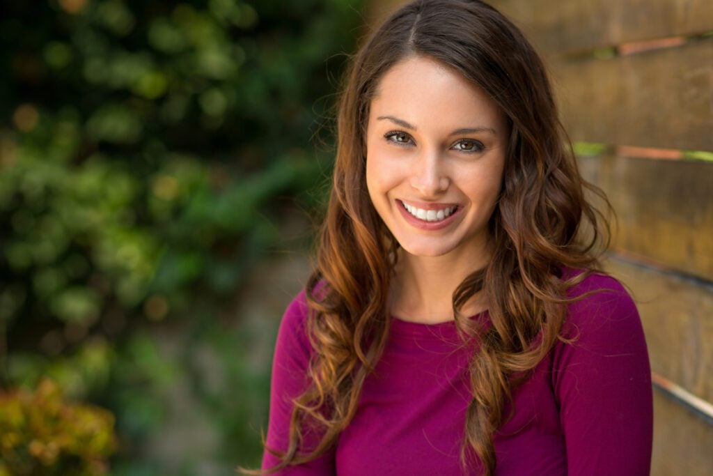 Portrait of a beautiful lady nice teeth from dental veneers in New York city