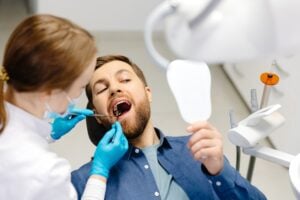 man in a dental chair getting a routine dental checkup